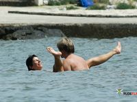 Nude Walk Past Clear Water and Sandy Rocks on the Shore