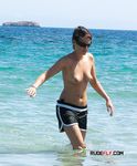 Fixing Her Towel Beside the Sea on a Sunny Afternoon