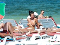 Multiple beautiful brunettes with slim bodies and perky tits fool around in the water and walk on the beach topless 3