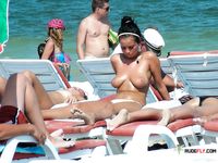 Multiple beautiful brunettes with slim bodies and perky tits fool around in the water and walk on the beach topless 3