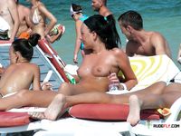 Multiple beautiful brunettes with slim bodies and perky tits fool around in the water and walk on the beach topless 3