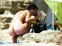 She lies down with her slim legs slightly spread, showing off her beautiful, tight, trimmed pussy 2