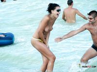 Blonde topless nudist woman enjoys her time at a nudist camp with her titties out 2