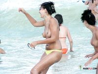 Blonde topless nudist woman enjoys her time at a nudist camp with her titties out 2