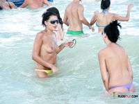 Blonde topless nudist woman enjoys her time at a nudist camp with her titties out 2