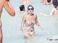 Blonde topless nudist woman enjoys her time at a nudist camp with her titties out 2