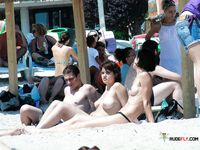 Gorgeous brunette sits outdoor topless, showing off a pair of perfect breasts, not caring anyone can see her 4