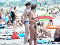 A nudist family enjoys their day at the beach