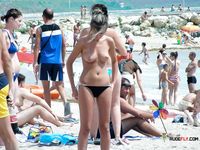 A nudist family enjoys their day at the beach