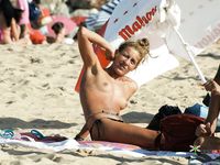 Hot redhead loves being on a naked beach, where she can be totally nude, lay on the sand, and spread her legs to feel the wind on her shaved pussy