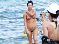 Sitting on a Beach Towel with Earphones at a Nude Beach