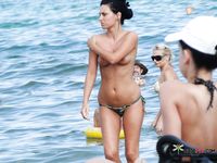 Sitting on a Beach Towel with Earphones at a Nude Beach