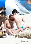 Two Adults Relax by the Shore on a Sunny Beach