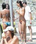 Gentle Shallow Waves Frame a Topless Beach Walk