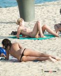 She walks around the beach with her wide hips, bubbly ass, and natural tits showing 3