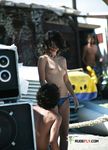 Topless and Wading Into the Water at the Beach