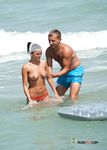 Flower in Her Hair on a Busy Naturist Beach