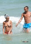 Flower in Her Hair on a Busy Naturist Beach