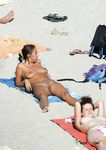 Brunette amateur stunner drops her bra and panties as she enjoys the sun on the rocks near the sea, not knowing that voyeur is filming her