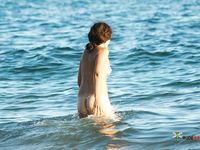 Running Through Ocean Waves on a Bright Nude Beach