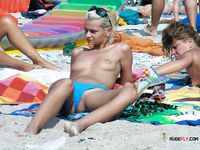 Topless on a Sandy Beach Towel Under Summer Sun
