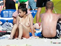 Stunning naturist blonde secretly filmed by a voyeur sitting and sunbathing topless 2