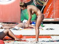 Stunning naturist blonde secretly filmed by a voyeur sitting and sunbathing topless 2