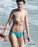 Voluptuous naturist couple enjoys their time at the beach as they go for a swim and cuddle on the towels