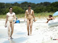 Chubby chick sprays her body on a naked beach 2