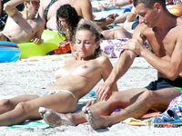 Chubby brunette mom loves her time in nudist park as she is displaying her saggy tits while having a laugh and looking around on the beach 2