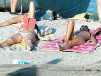 Beautiful, slim nudist babes filmed at the beach on a voyeur camera