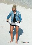 Curvy nudist blonde caught on camera enjoying her day at the beach topless 2