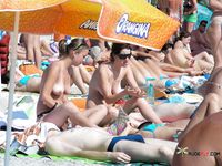 Skinny brunette with a fit body plays tennis with her perky tits out while other girls sunbathe topless 2