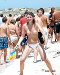 Voyeur catches a dashing nudist babe sunbathing naked on the beach