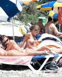 Girls with tiny tits walk around topless and have fun in the water while others sit around and talk 3