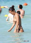 This beautiful nude beach girl shows off her perky tits before lying down with her pussy and ass secretly filmed