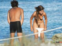 Naakt in het heldere strandwater met iets in de hand