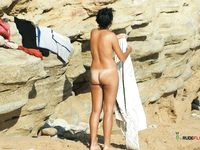 Two hot chicks, a blonde and a brunette are fully naked and enjoy lying at the beach in a nudist resort, while they feel the Sun heat on their bodies 2