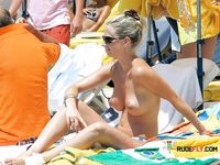 She gets secretly filmed as she applies sunscreen before sunbathing her big, natural tits and a slim body 4