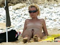 Two hot family nudist sisters lay naked next to each other on the beach as the eyes of the passing bys go from their tits to their sexy feet