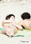 Holding a Wooden Board at a Topless Beach
