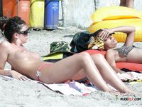 Dazzling blonde lies on her stomach with her firm butt showing and pale brunette sunbathes her perky tits 3