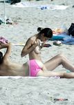 Gorgeous nubile swims naked before playing in the sand and rubbing her soft pussy 4