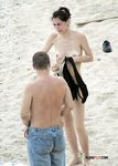 This nude beach girl enjoys tanning her fit, slim body with a pair of supple, rounds breasts on display 3