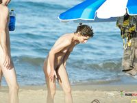 Bikini Bottom Adjustment With Ocean Waves and a Blue Umbrella Nearby