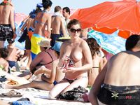 Sunlit Topless Sunbathing Beside the Open Ocean