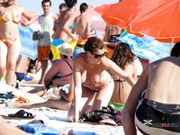 Sunlit Topless Sunbathing Beside the Open Ocean