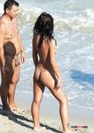 Standing Nude by the Waves on an Open Beach