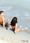 Standing Nude by the Waves on an Open Beach