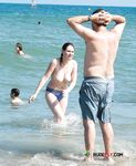 Wading from the Surf Topless in Yellow Bikini Bottoms